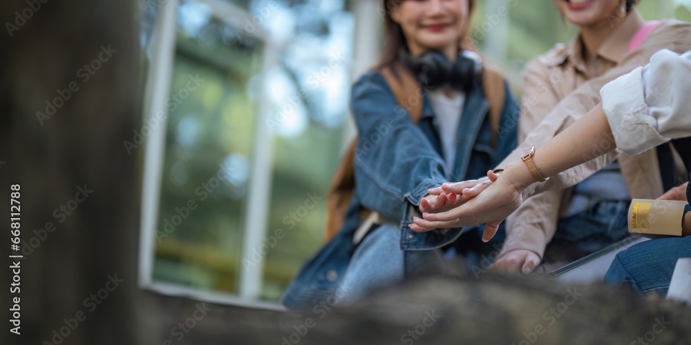 Student university friendship concept with classmate sitting together at campus college park. Youth teenage and education