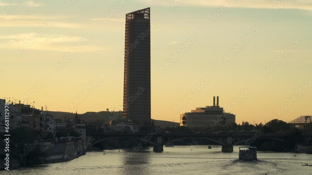 Silhouette sunset on Guadalquivir river in Seville, the capital of Andalusia region in south Spain Silhouette sunset on Guadalquivir river in Seville, the capital of Andalusia region in south Spain