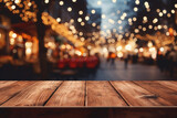 Empty wooden table and blurred background of Christmas market in city.