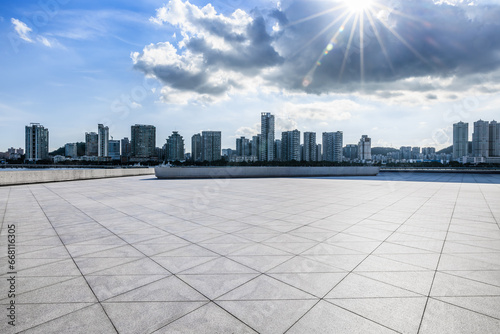 Empty square floors and residential area buildings under blue sky