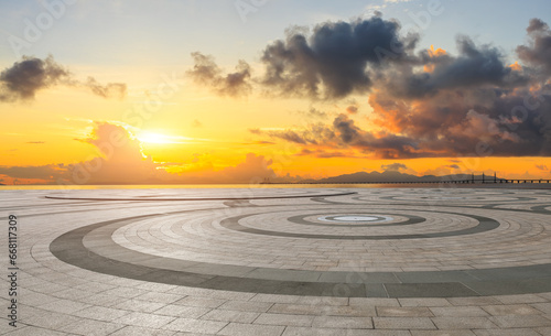 Round square floor and coastline with sky clouds at sunrise