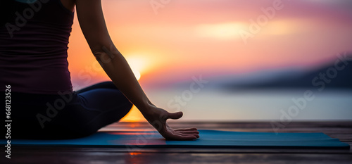 Woman Yoga at sunset.  Young woman is practicing yoga at mountain lake. Relax in nature
