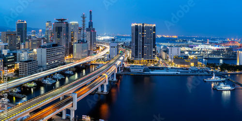 Kobe skyline from above with port and elevated road panorama at twilight in Japan