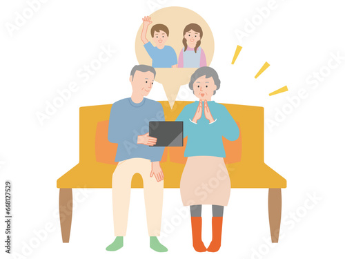 孫の動画をタブレットで視聴するシニアのカップル