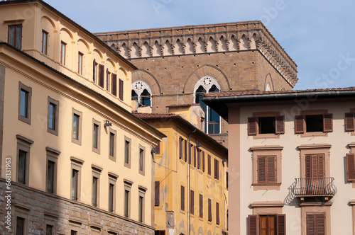 Colorful historic streets of Florence, Italy. Narrow old street, building's facade, brick walls.