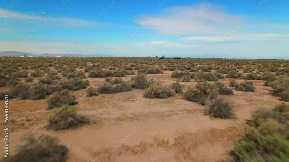 Aerial Forward Shot Of Abandoned Structures Amidst Plants In Desert Against Sky - Landers, California Aerial Forward Shot Of Abandoned Structures Amidst Plants In Desert Against Sky - Landers, California