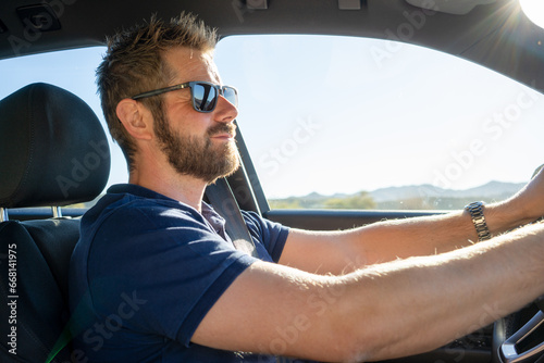 View of a Young attractive man driving his car
