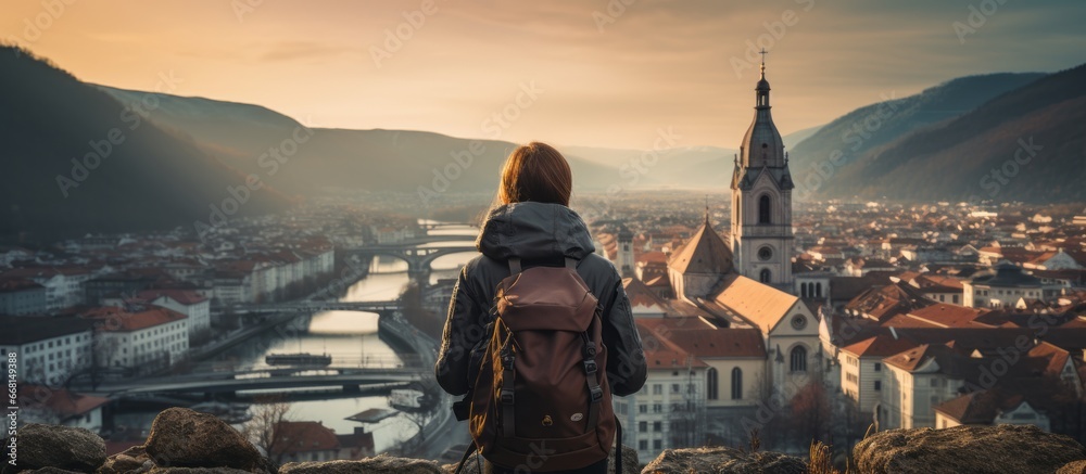 casual solo traveller female woman standing on the hill look over aerial topview of old famous attraction city travel concept carefree leisure freedom concept - obrazy, fototapety, plakaty 