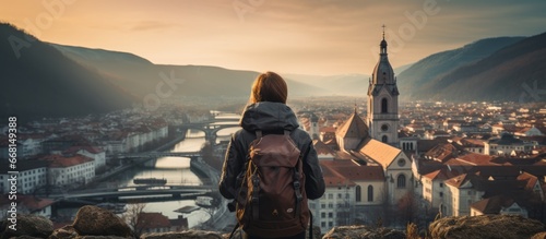 casual solo traveller female woman standing on the hill look over aerial topview of old famous attraction city travel concept carefree leisure freedom concept photo