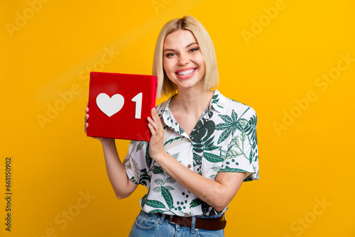 Photo of funky cheerful lady wear print shirt holding like heart sign smiling isolated yellow color background