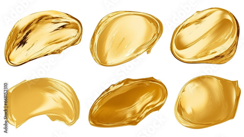 Artistic brushstrokes of gold paint isolated on a white background. Gold paint texture.