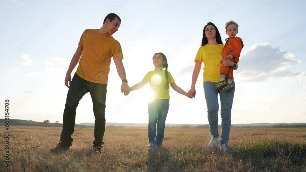 People are walking in park. Happy family walk of parents with children at sunset in sun. Family walk with children outdoors in park. Green family park. Family lifestyle of parents. People are walking in park. Happy family walk of parents with children at sunset in sun. Family walk with children outdoors in park. Green family park. Family lifestyle of parents.