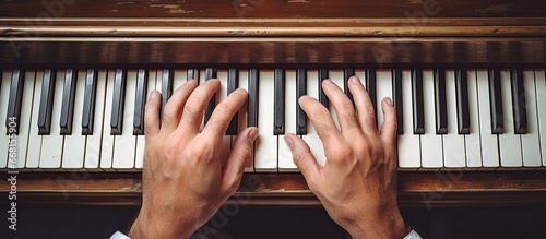 Birds eye view of Caucasian male pianist gently playing antique piano Vintage tones Music and musicians concept