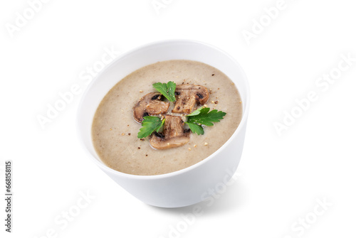 Roasted mushroom potato puree soup in a bowl on a white isolated background