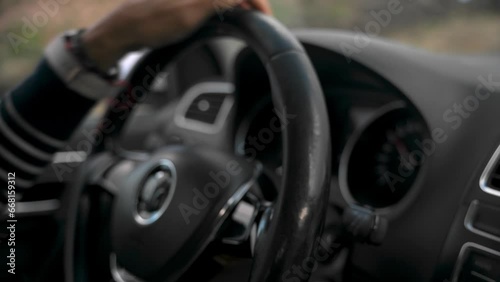 Unrecognizable person driving car on roadway of countryside in daylight