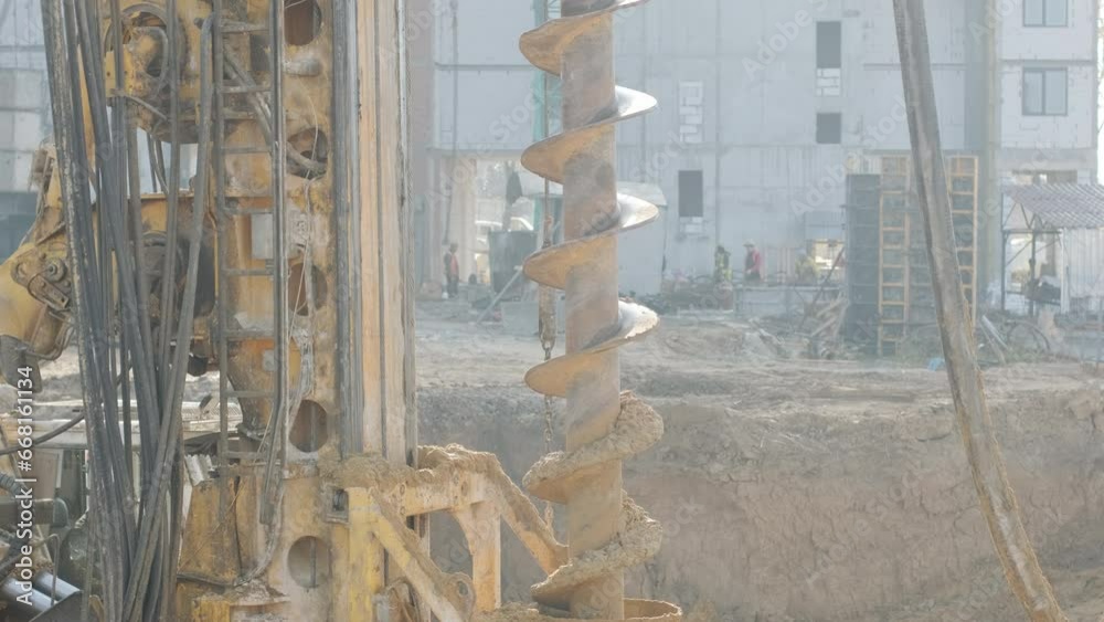 Equipment for installing piles in ground, heavy machines for driving pillars work in laying the foundation building. Construction aerial view height. Construction site drilling pile foundation.