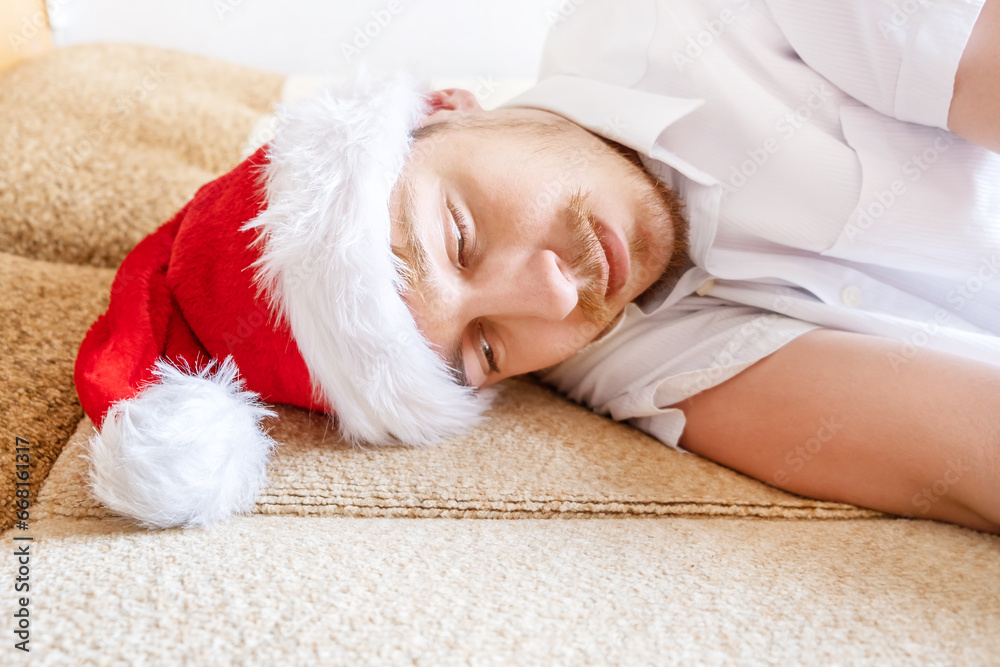 Tired Young Man in Santa Hat Tired Young Man in Santa Hat