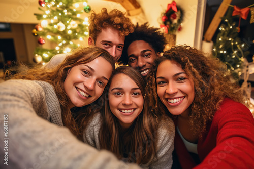 Friends multiracial smiling taking selfie at home on Christmas © Ivan Guia