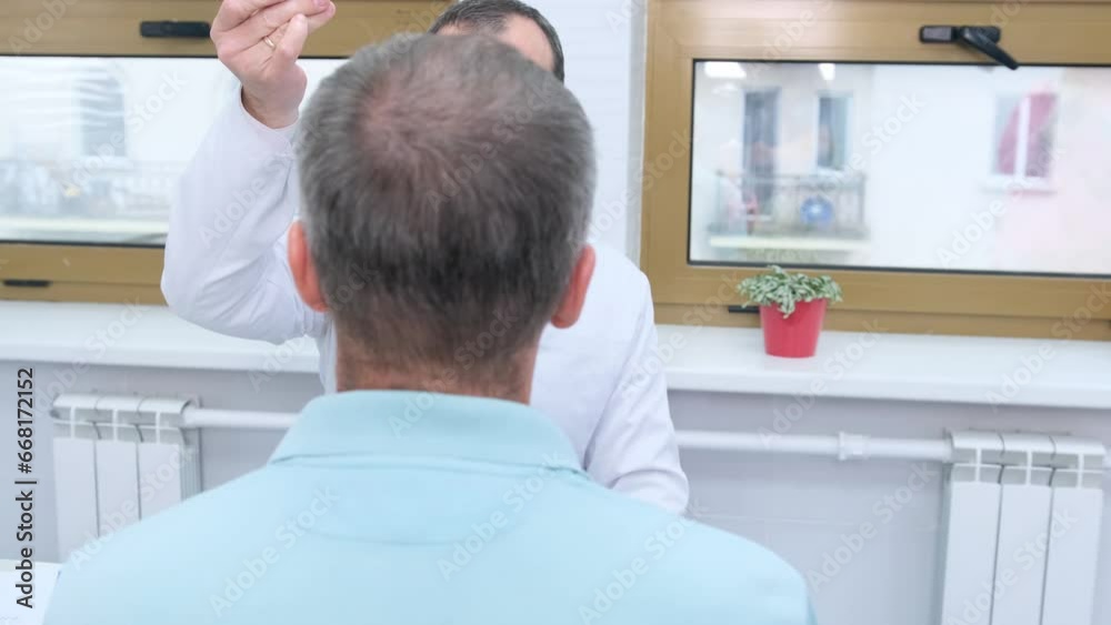 a male neurologist drives a hammer in front of the patient's eyes during a routine examination at the clinic.