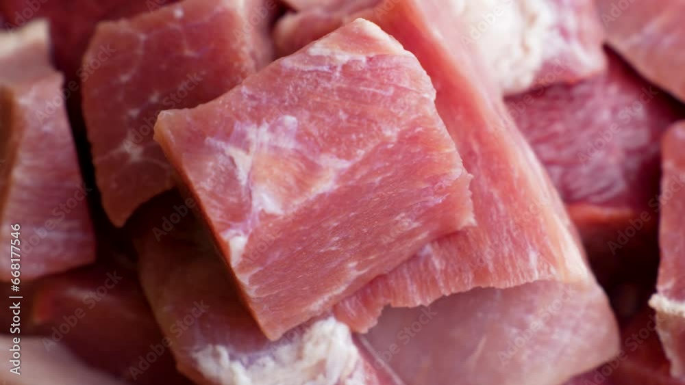 Raw beef meat chopped in cubes, 4k slow motion Raw beef meat chopped in cubes, 4k slow motion