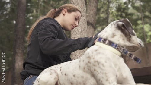 Pet and owner in the field while she drinks coffee