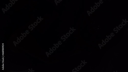 the girl lying on the bed inside the cabin turns off the light on the bedside table.the girl lying on the bed inside the cabin turns off the light on the bedside table.