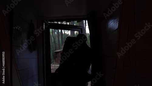 the birdwatcher boy and his dog leave the shelter at dawn