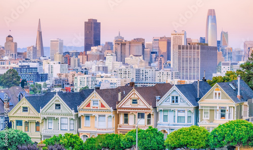 Painted Ladies Victorian houses in Alamo Square and a view of the San Francisco skyline and skyscrapers. Photo processed in pastel colors © Volodymyr