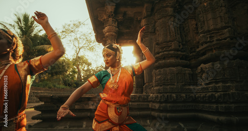 of Female Indian Lead Dancer Explaining to her Team Dancers the Moves of a Traditional Choreography. Girls in Colorful Clothes Rehearsing for a Performance in an Ancient Temple