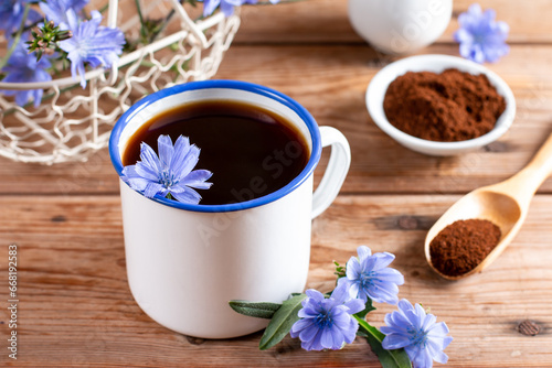 Healthy chicory beverage and blue flowers on a table. Coffee substitute.