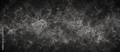 Abstract texture with monochrome particles on a dark design background surface