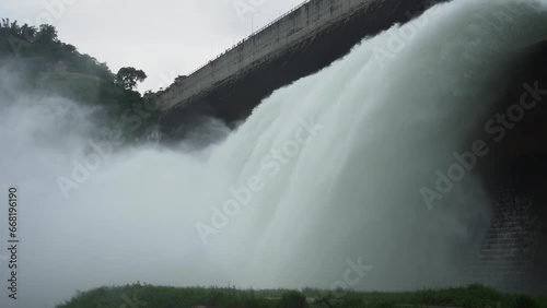 Hydroelectric dam Floodgate with flowing water through gate and Open the springway Khun Dan Prakan Chon Dam in nakhon nayok Thailand photo