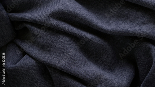 Dark texture of the fabric with folds