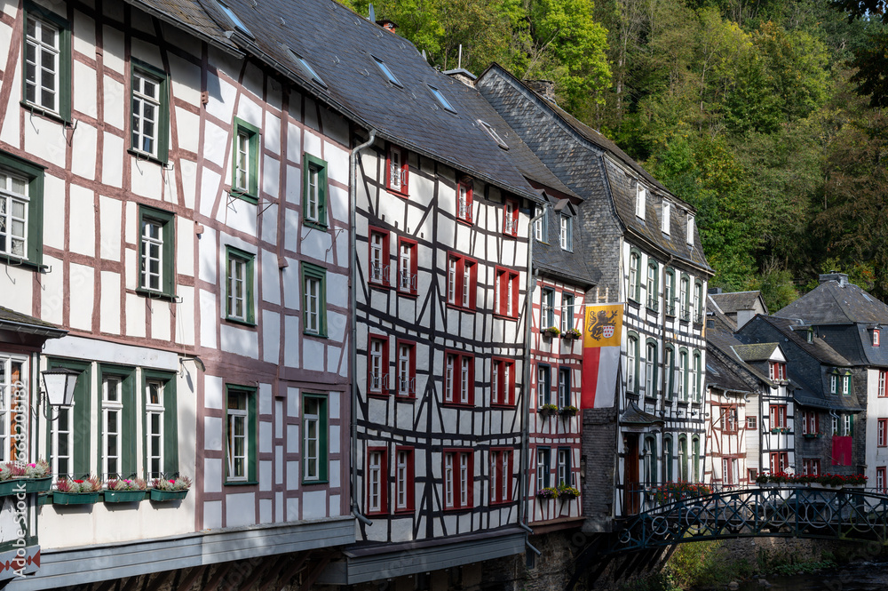 View of houses and streets of old colourful German town Monschau in bend of the river and hidden between the hills, Eifel national park, Germany