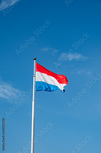 Views of flag of Luxembourg country and blue sky in Luxembourg or Luxembourg City capital city and one of de facto capitals of European Union