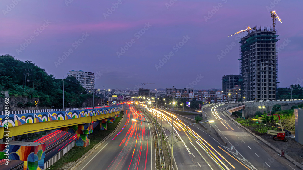 Obraz premium Slow shutter speed image of light trails, beautiful sunset sky ,