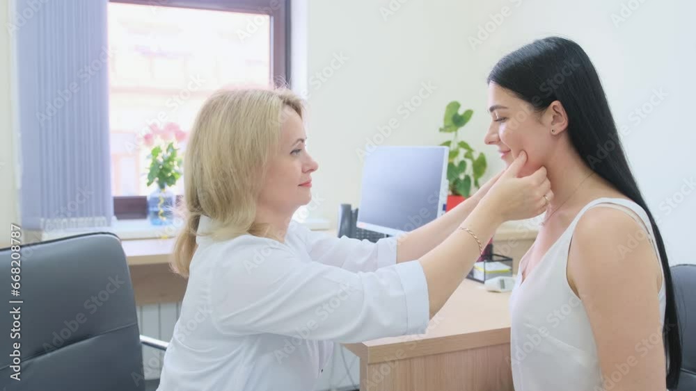a female doctor examines the patient's throat in the office. a female doctor examines the patient's throat in the office.