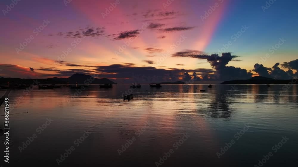 Aerial view beautiful sunrise above fishing boats and beautiful reflection in the water surface,Beautiful sunlight in the sea, Fishing boats are floating in the sea in Phuket island Thailand Aerial view beautiful sunrise above fishing boats and beautiful reflection in the water surface,Beautiful sunlight in the sea, Fishing boats are floating in the sea in Phuket island Thailand