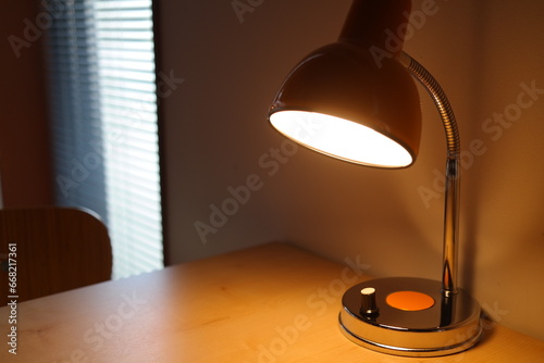 There is a lighted stand on the desk.