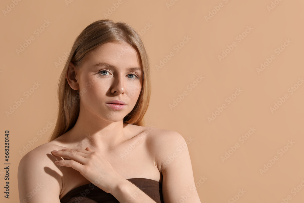 Beautiful young woman posing on beige background, space for text