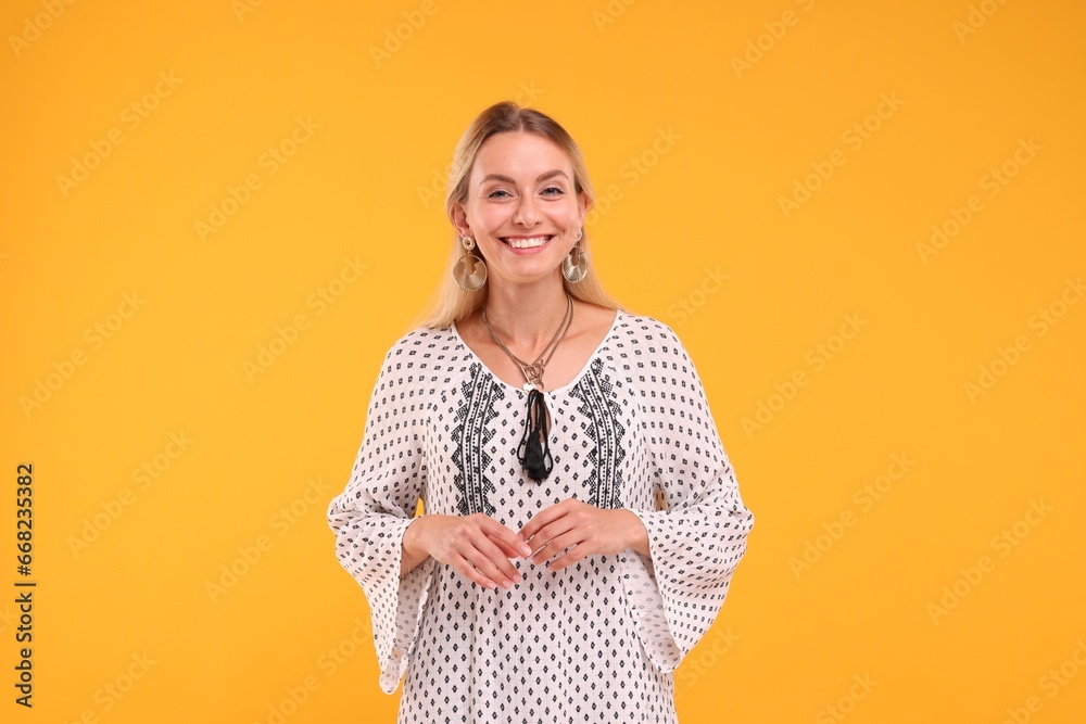 Portrait of smiling hippie woman on yellow background Portrait of smiling hippie woman on yellow background