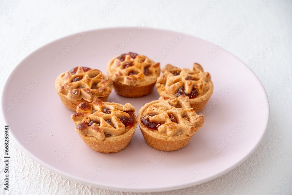 Apple pie on a pink plate on a white background Apple pie on a pink plate on a white background