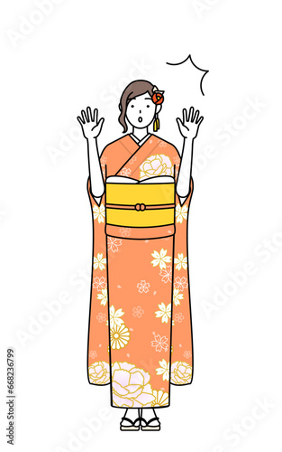 驚いて手を上げる振袖姿の女性、お正月の初詣や成人式、卒業式や結婚式などで