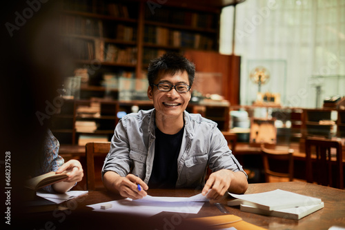 University student laughing during a group study in the library photo