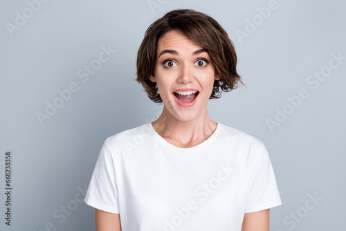 Photo of excited funky woman dressed white t-shirt open mouth isolated grey color background