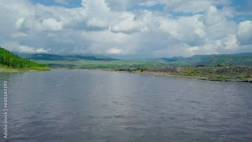 Calm River Flowing Near Beautiful Nature Scenery With Green Hills In Background. Beautiful River Located In Rural Area. Beautiful Slow River Stream. Nature. Forest Trees. Clean Environment. Clouds