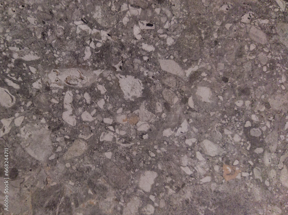 Old gray surface with dots. Gray background with a pattern. Concrete floor with stones. Old gray surface with dots. Gray background with a pattern. Concrete floor with stones.