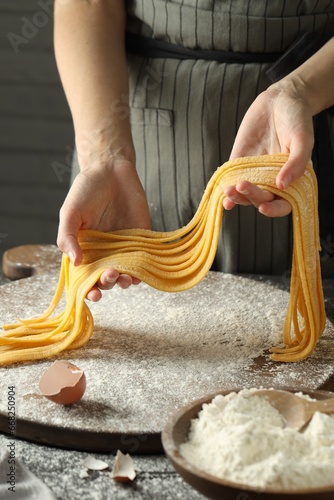 Canvastavla Woman making homemade pasta at table, closeup