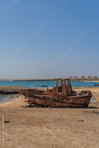 A old rusted boat on the sandy beach, east coast of Sal Island in Cape Verde