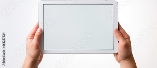 Empty screen being held by hands on tablet device photo